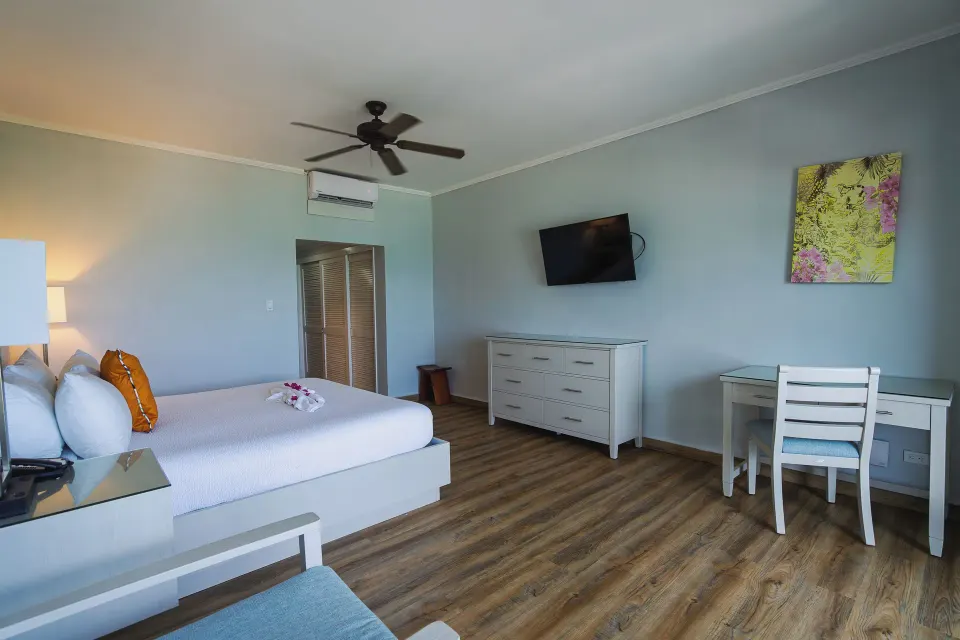 Oceanview king room with desk and dresser at Pineapple Beach Club Antigua.