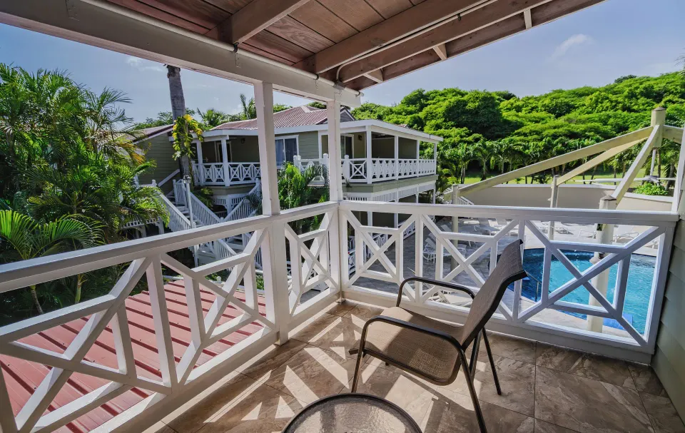 Pool Terrace balcony with chair and pool view at Pineapple Beach Club Antigua.