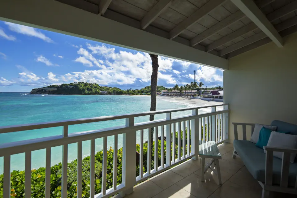 Waterfront room balcony with beach and bay view at Pineapple Beach Club Antigua.