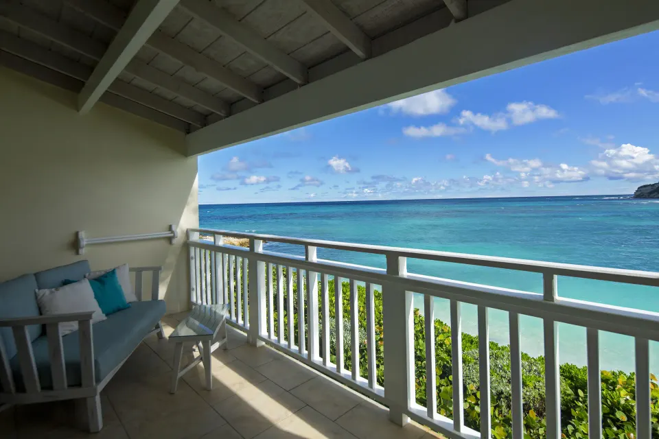 Waterfront room balcony facing turquoise sea at Pineapple Beach Club Antigua.