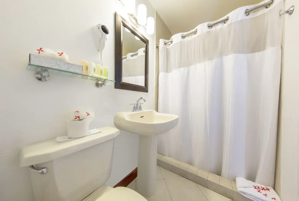 Waterfront room bathroom with pedestal sink at Pineapple Beach Club Antigua.