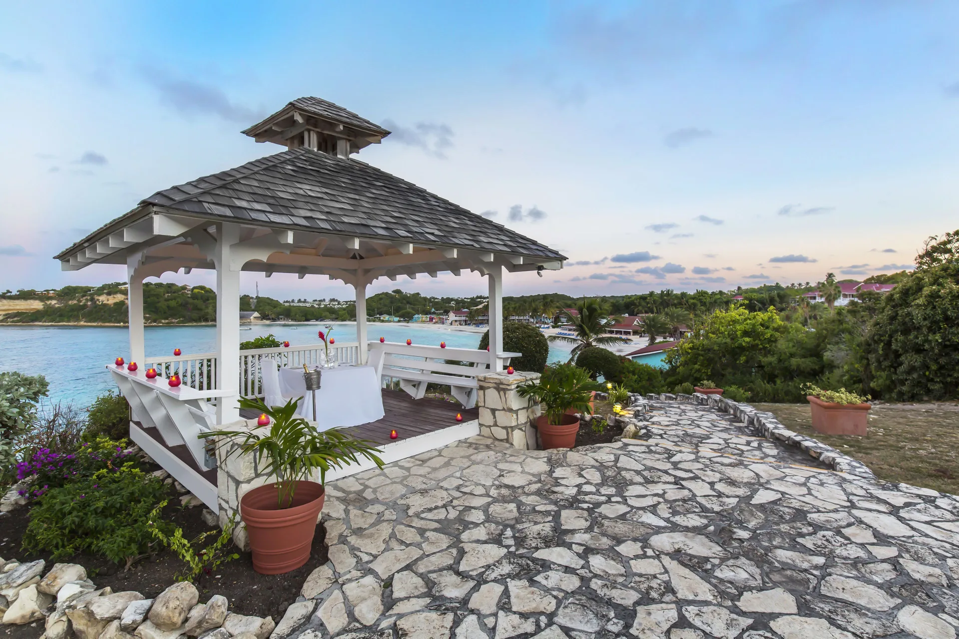 A seaside gazebo with candles overlooks the water at Pineapple Beach Club Antigua.