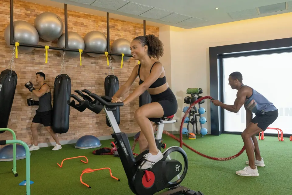 Guests exercise with bikes, ropes, and punching bags at Planet Hollywood Cancun.