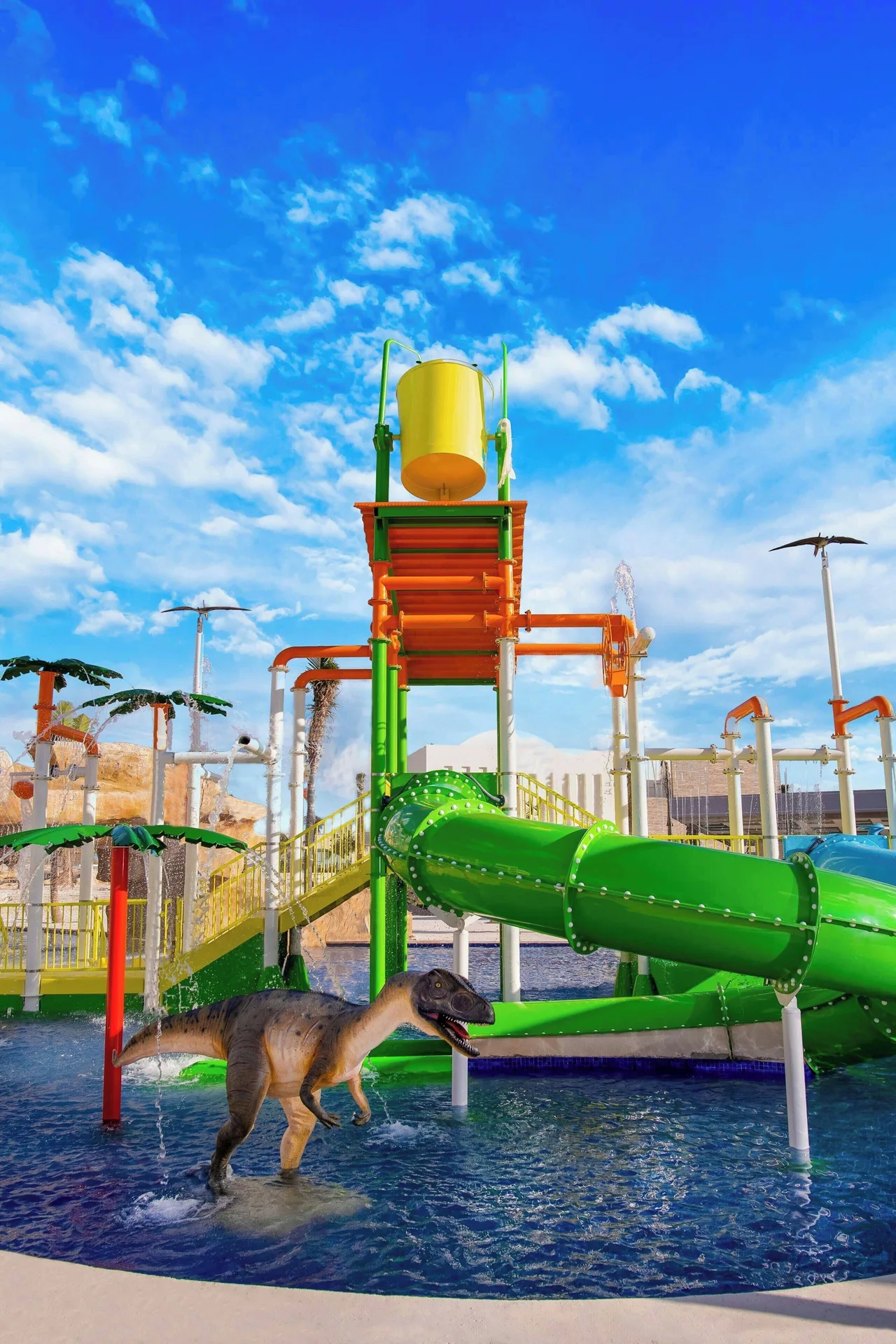 Colorful kids splash play area with a dinosaur figure at Planet Hollywood Cancun.