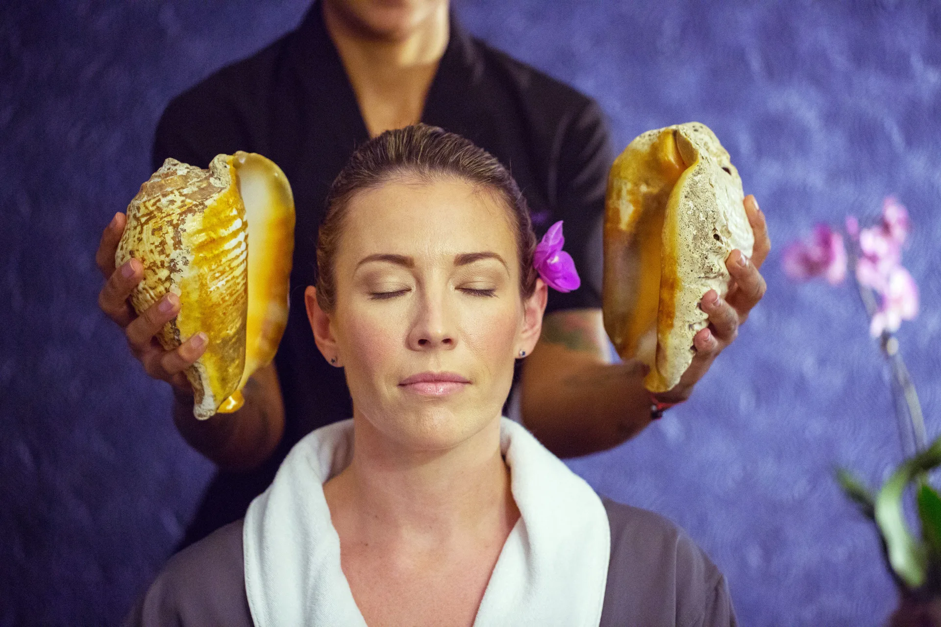 Guest receiving a shell sound therapy treatment at the spa at Planet Hollywood Cancun.