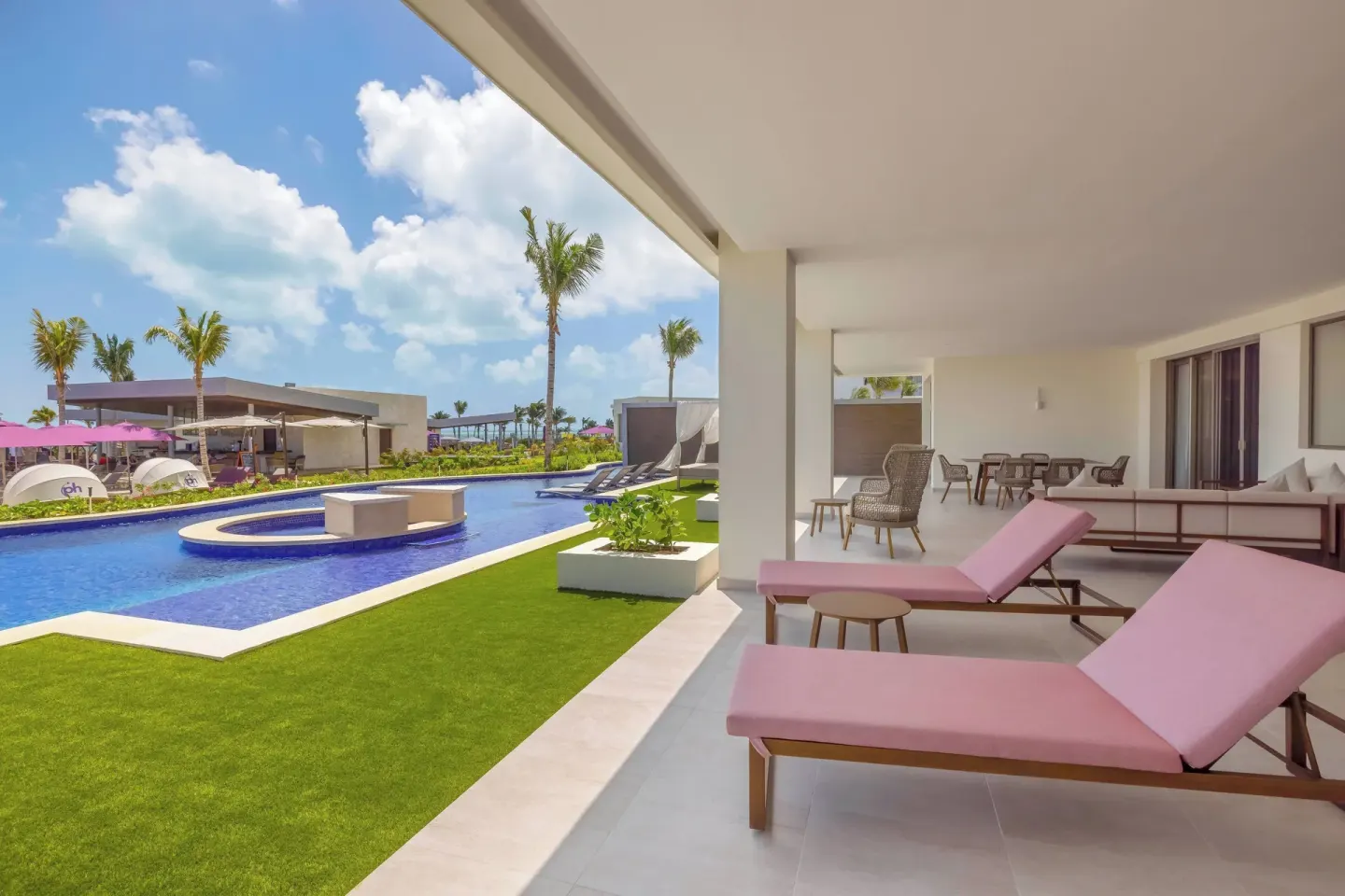 Covered swim-out terrace with pink loungers and pool access at Planet Hollywood Cancun.