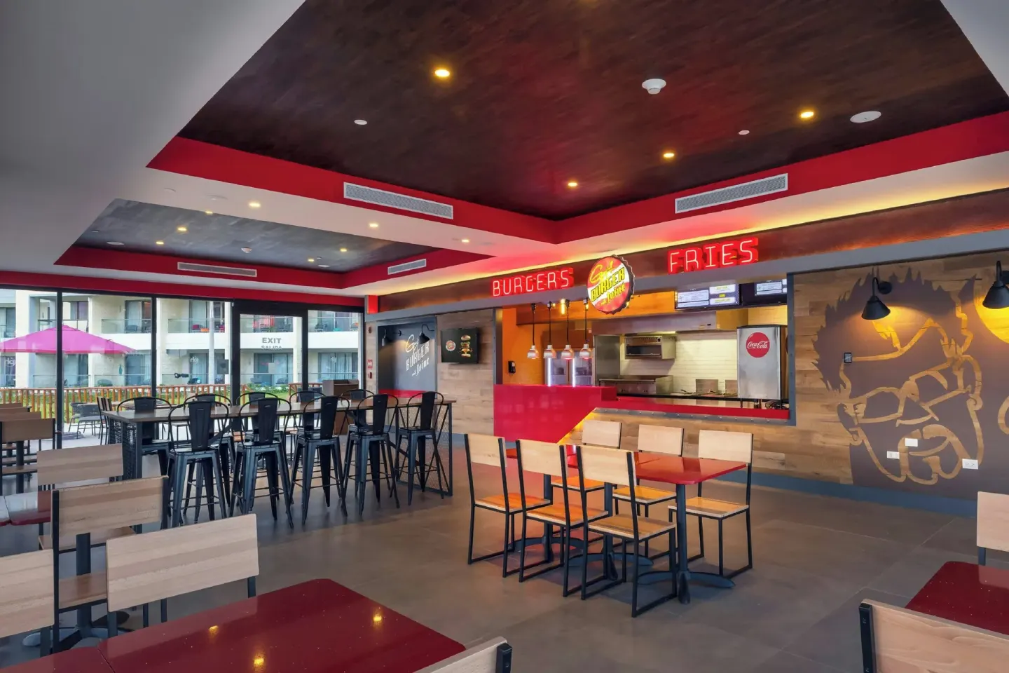 Burger counter with fries sign and casual seating at Planet Hollywood Cancun.
