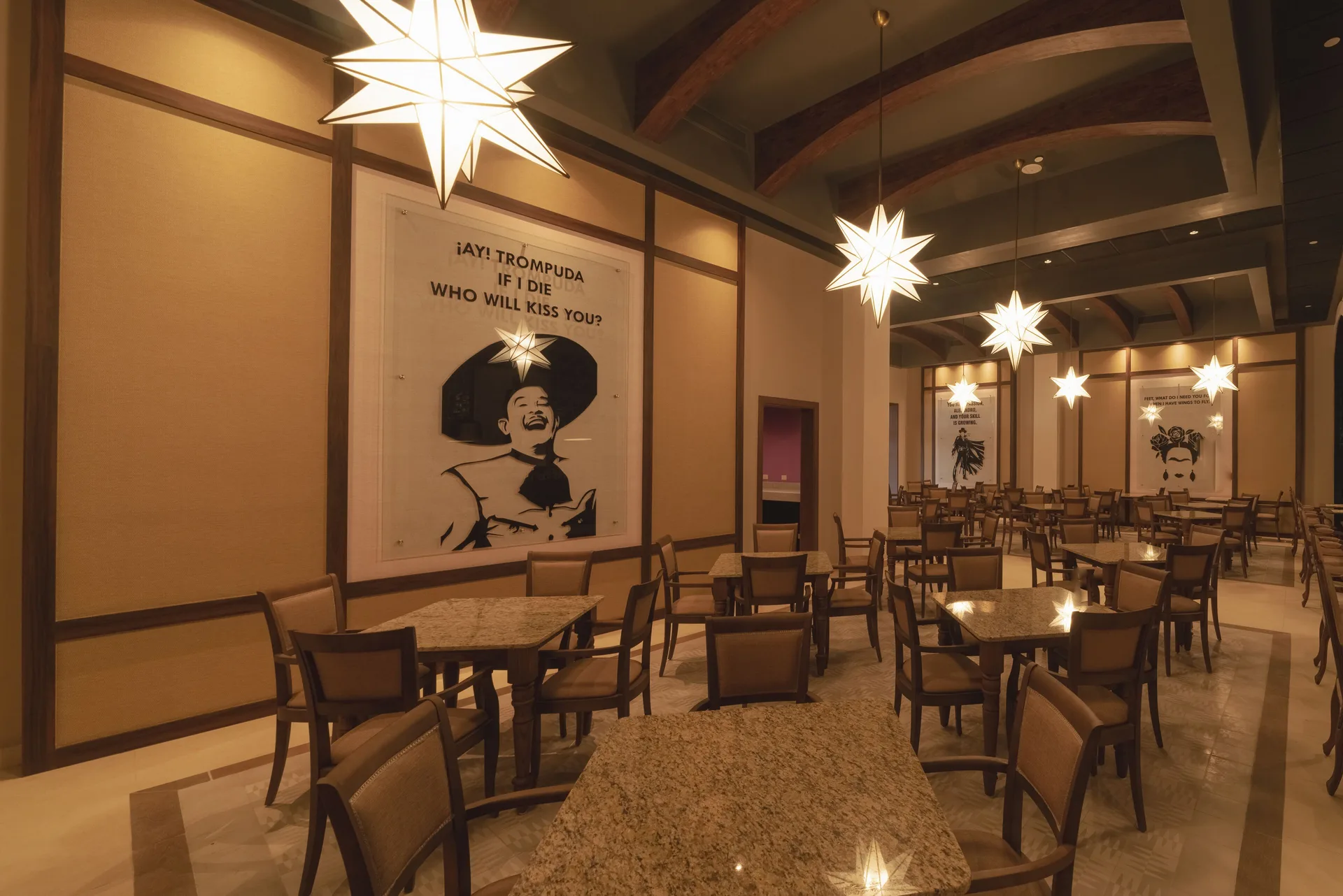 Warm Mexican restaurant dining room with star pendant lights at Planet Hollywood Cancun.