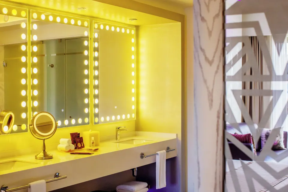 Directors Suite One Bedroom vanity with illuminated mirrors at Planet Hollywood Cancun.