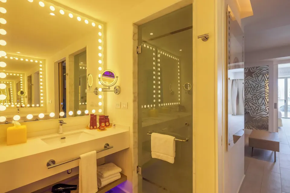 Entourage Suite bathroom vanity and glass shower at Planet Hollywood Cancun.