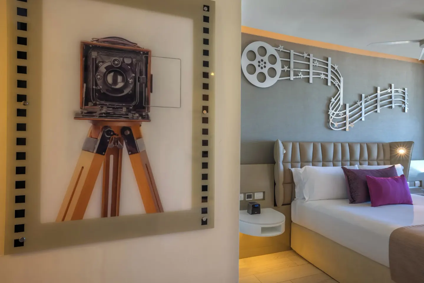 Junior Suite Ocean View bed and cinema-themed wall art at Planet Hollywood Cancun.