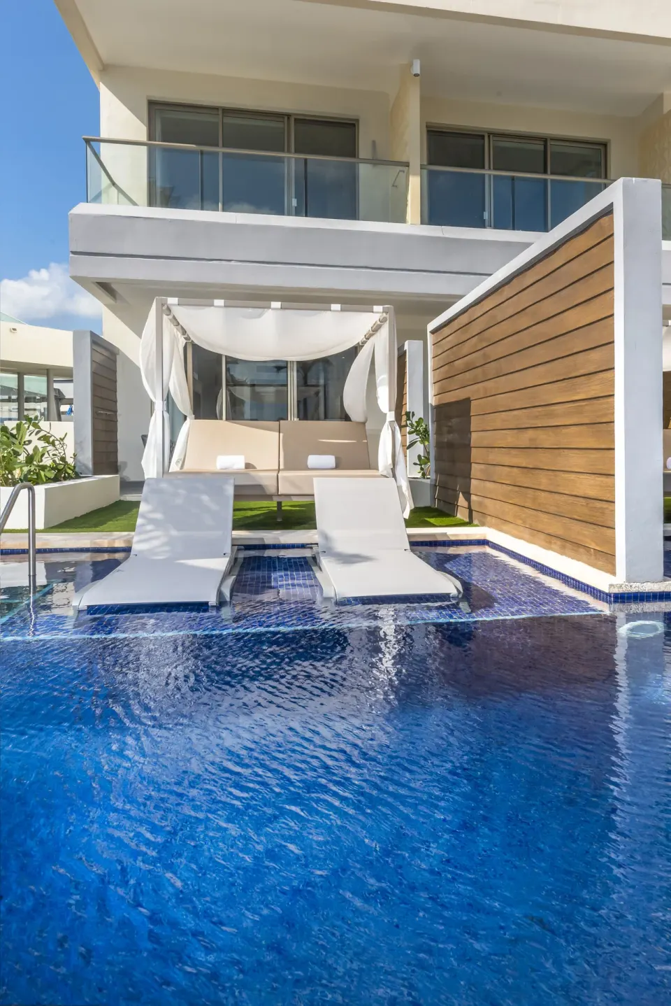 Swim-out terrace with loungers and cabana at the Junior Suite Swim Out at Planet Hollywood Cancun.
