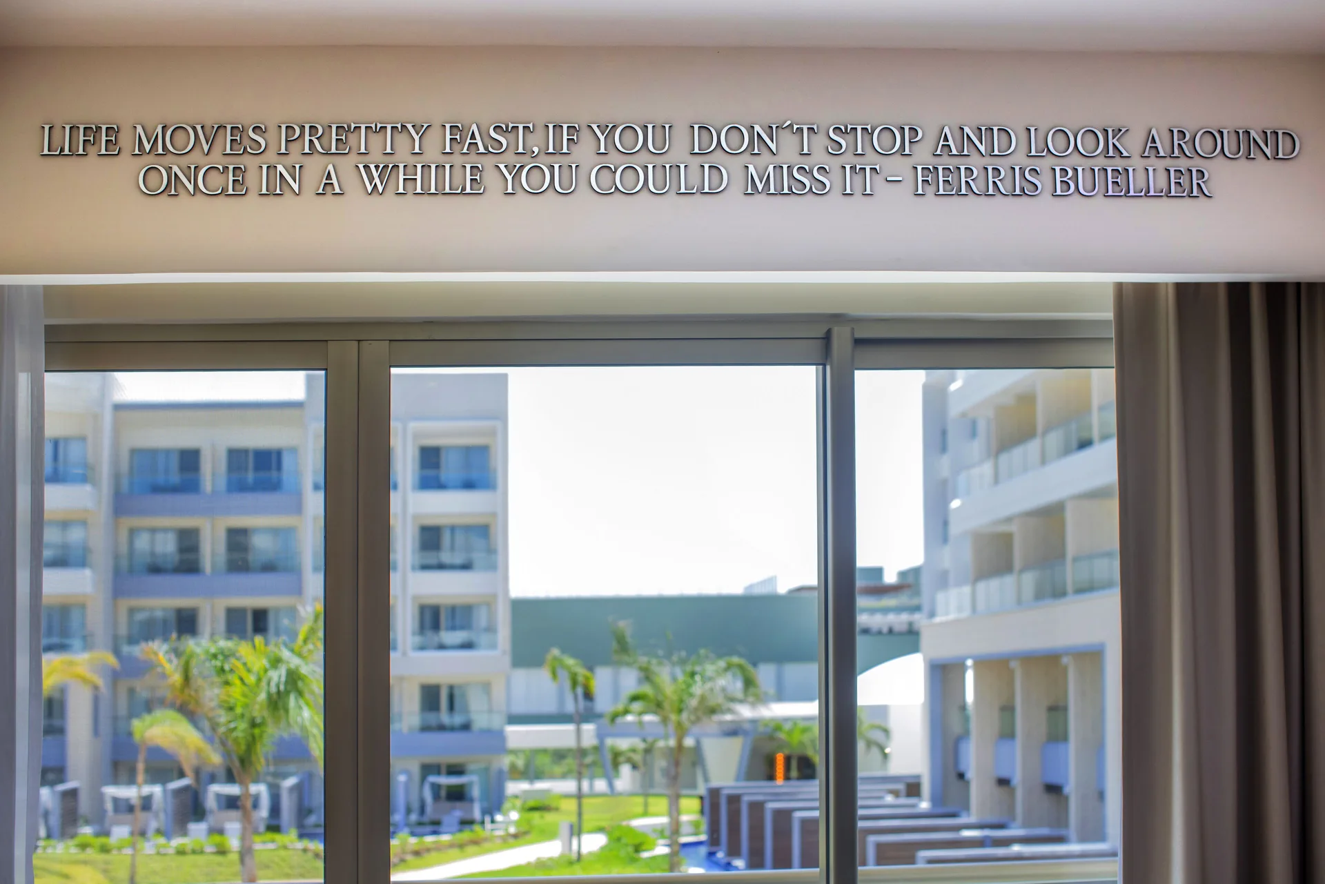 Junior Suite window view with movie quote wall at Planet Hollywood Cancun.