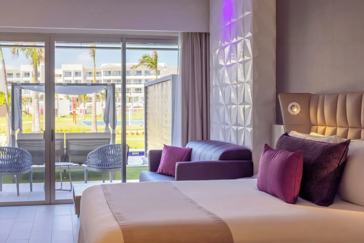 Star Class Directors Suite king bed and patio view at Planet Hollywood Cancun.