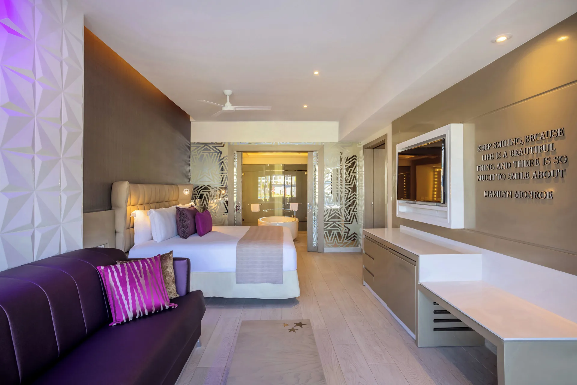 Star Class Directors Suite bedroom with king bed and sofa at Planet Hollywood Cancun.