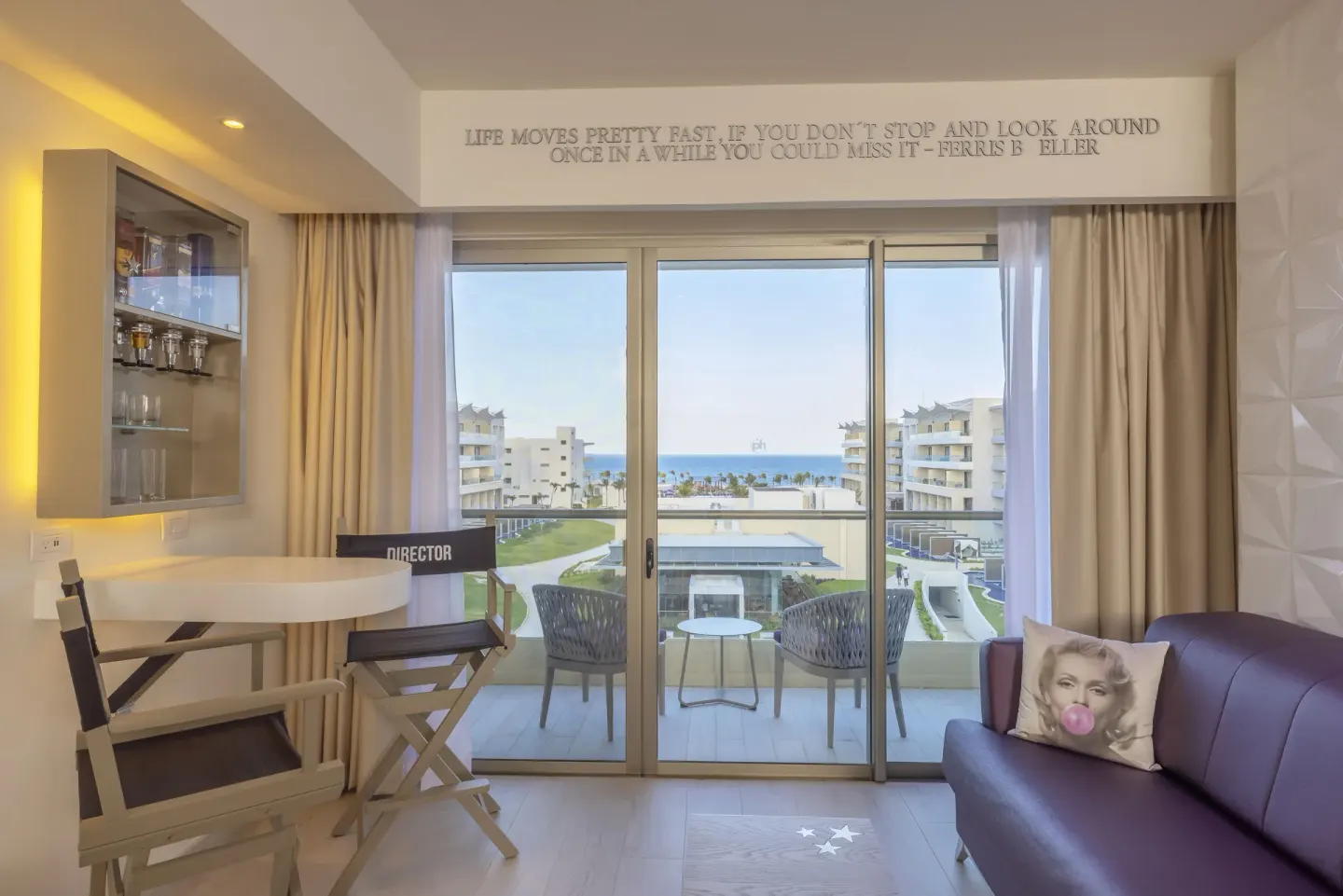 Star Class Junior Suite sitting area with balcony ocean view at Planet Hollywood Cancun.
