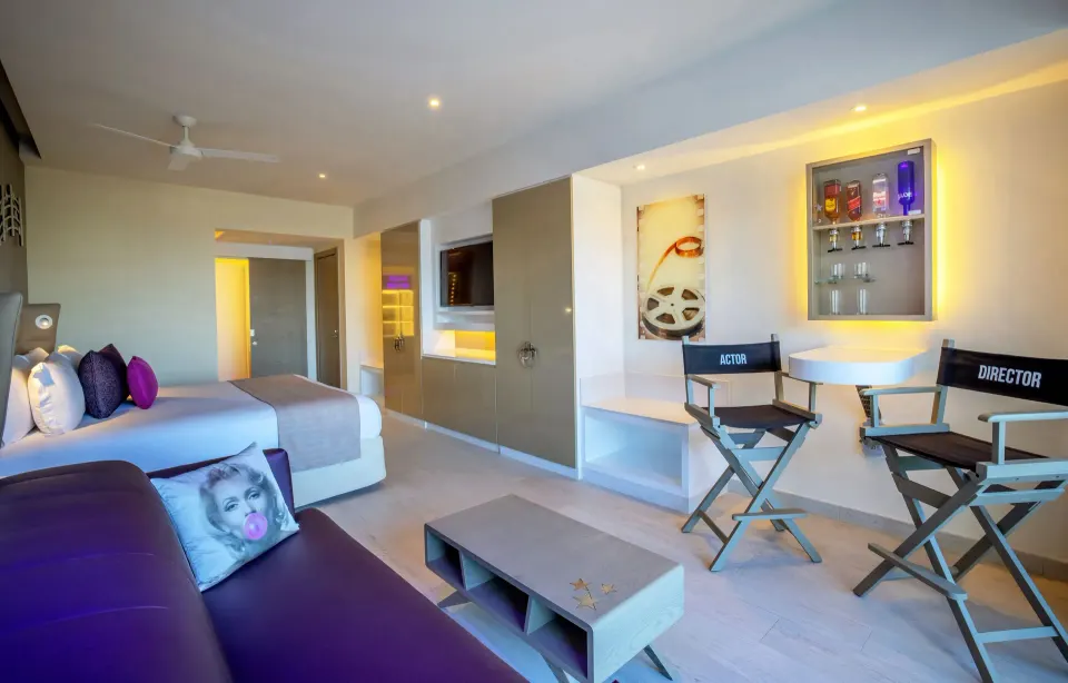 Star Class Junior Suite with king bed, sofa, and director chairs at Planet Hollywood Cancun.
