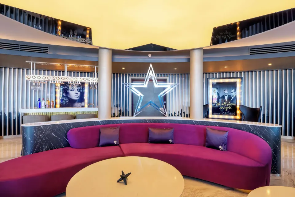 Curved lounge and bar in the Star Class Producers Two Bedroom Suite at Planet Hollywood Cancun.