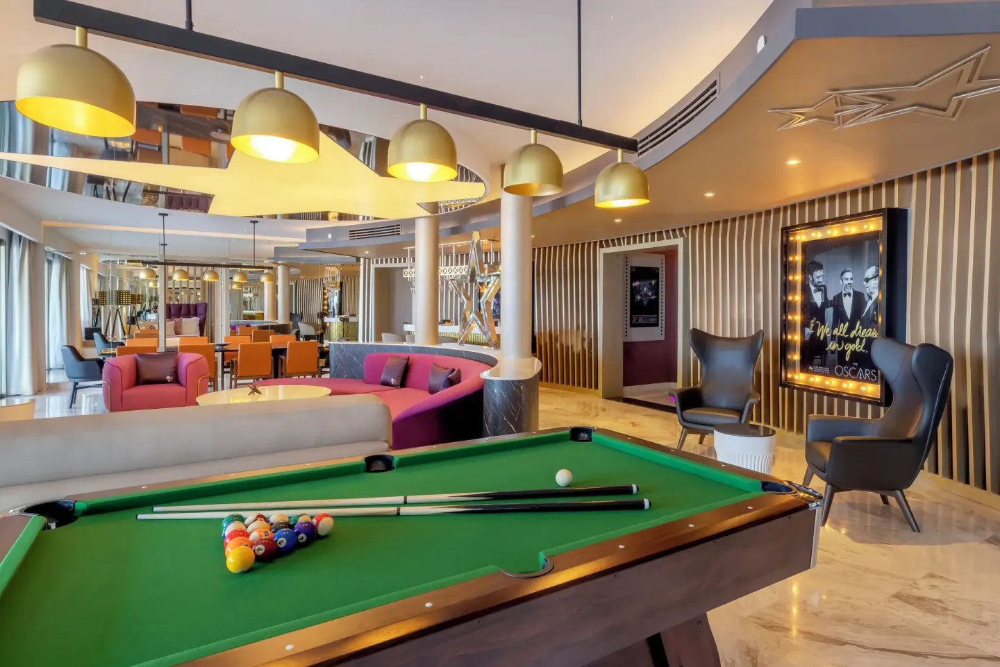 Pool table and lounge area in the Star Class Producers Two Bedroom Suite at Planet Hollywood Cancun.