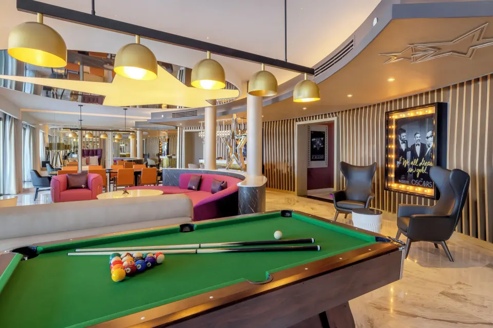Pool table and lounge area in the Star Class Producers Two Bedroom Suite at Planet Hollywood Cancun.