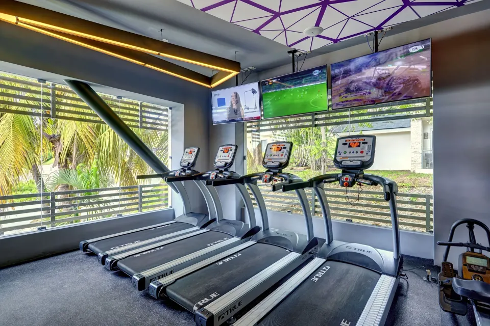 Treadmills facing windows in the gym at Planet Hollywood Costa Rica.