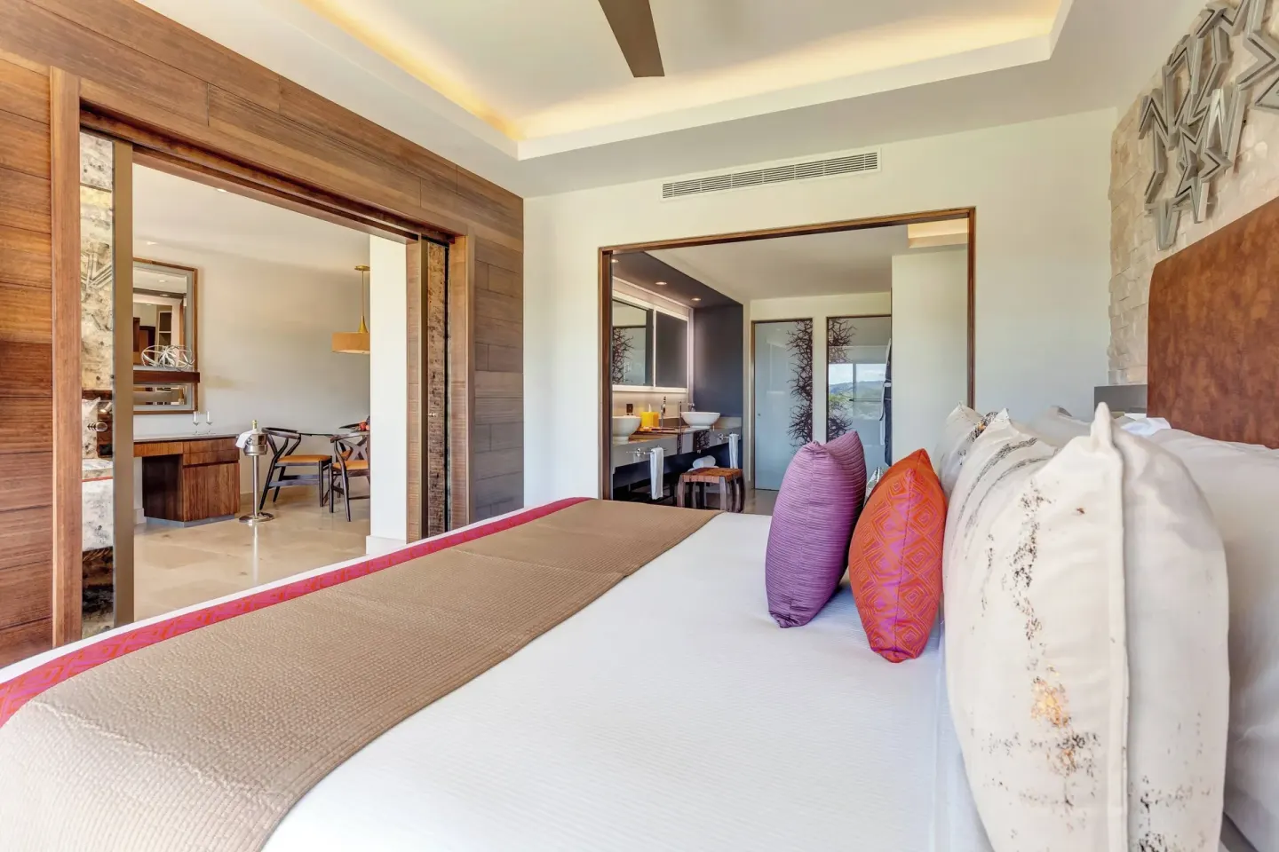 King bed guest room with vanity and dining area at Planet Hollywood Costa Rica.