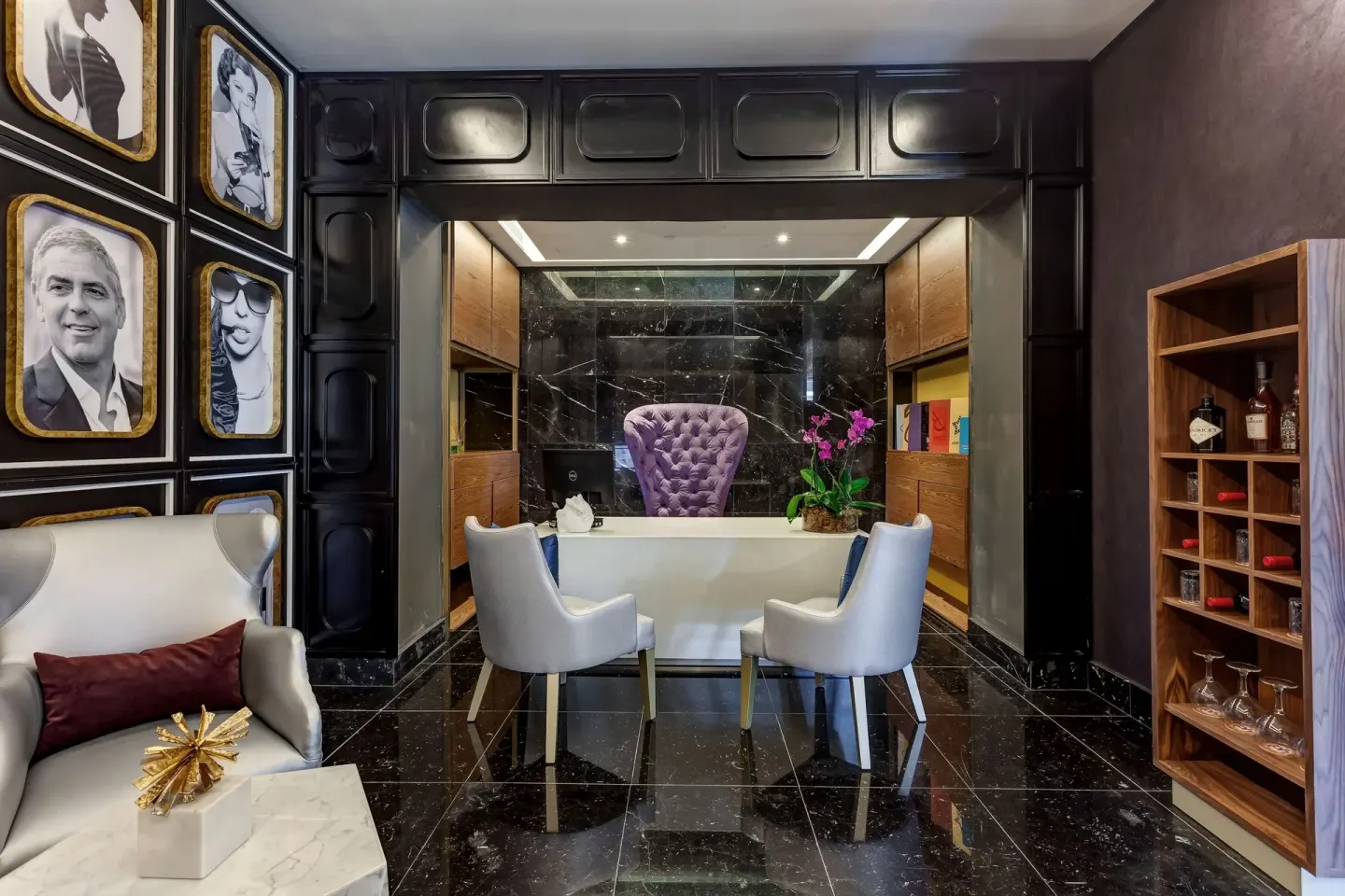 Concierge-style desk with portrait wall at Planet Hollywood Costa Rica.