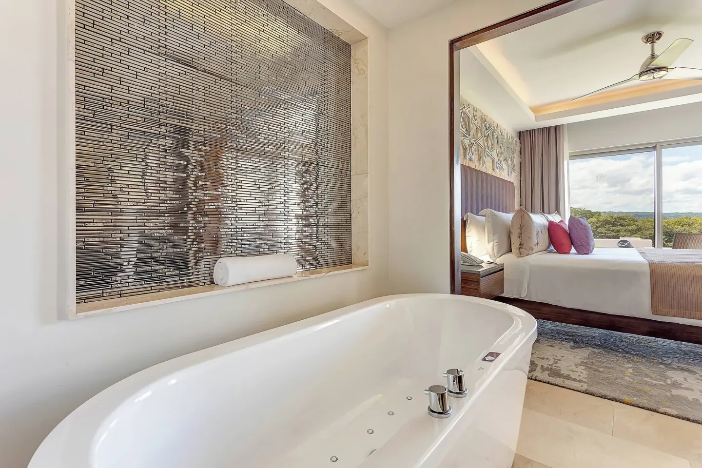 Soaking tub beside a king bedroom at Planet Hollywood Costa Rica.