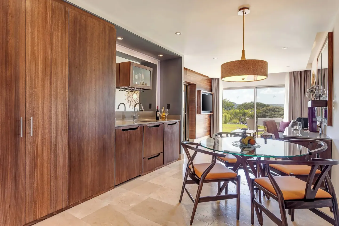 Suite dining area with kitchenette and balcony view at Planet Hollywood Costa Rica.