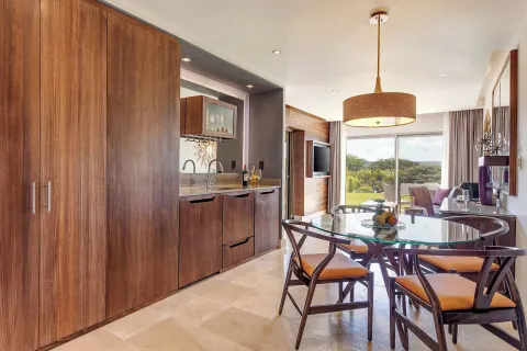Suite dining area with kitchenette and balcony view at Planet Hollywood Costa Rica.