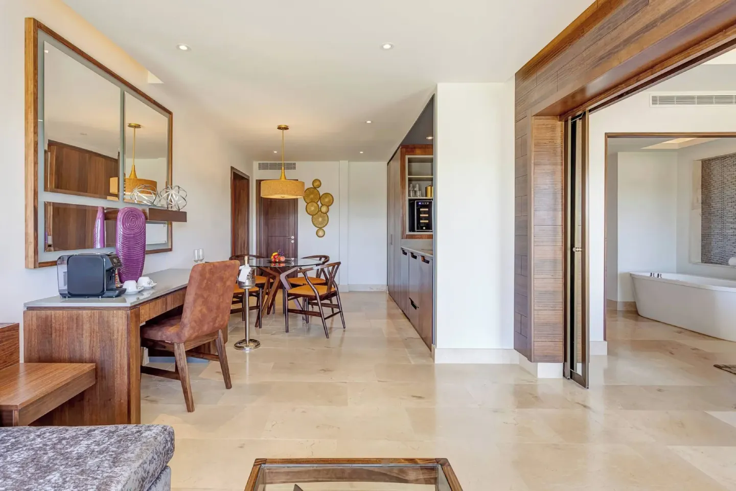 Suite living and dining area with a bathroom doorway at Planet Hollywood Costa Rica.