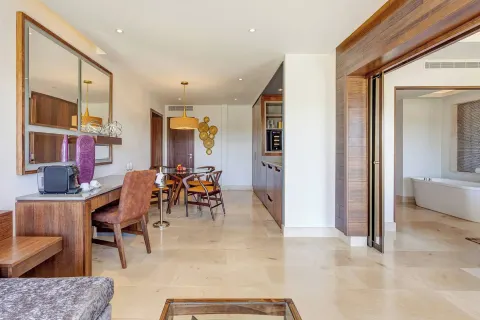 Suite living and dining area with a bathroom doorway at Planet Hollywood Costa Rica.