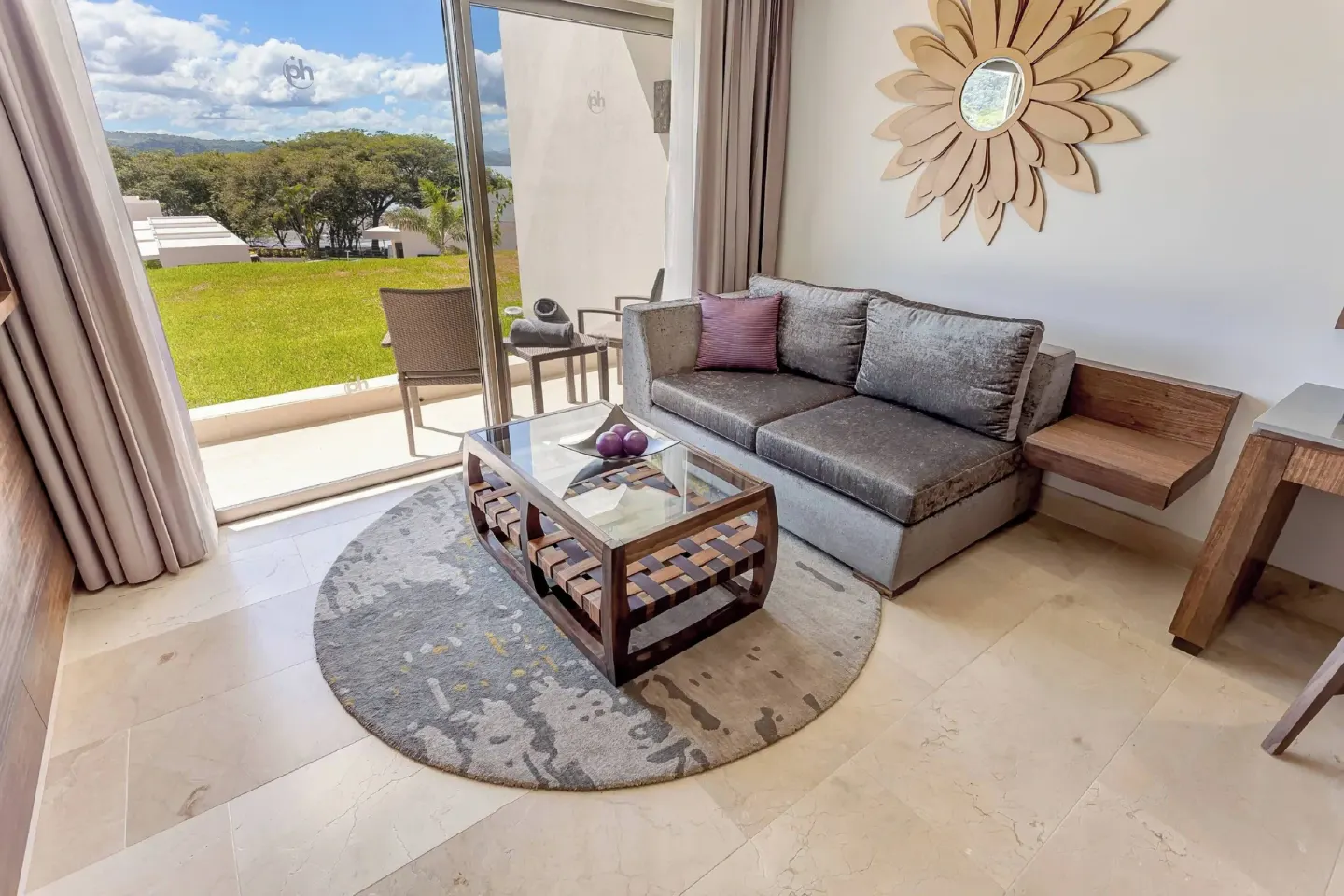 Suite sitting area with sofa and terrace at Planet Hollywood Costa Rica.