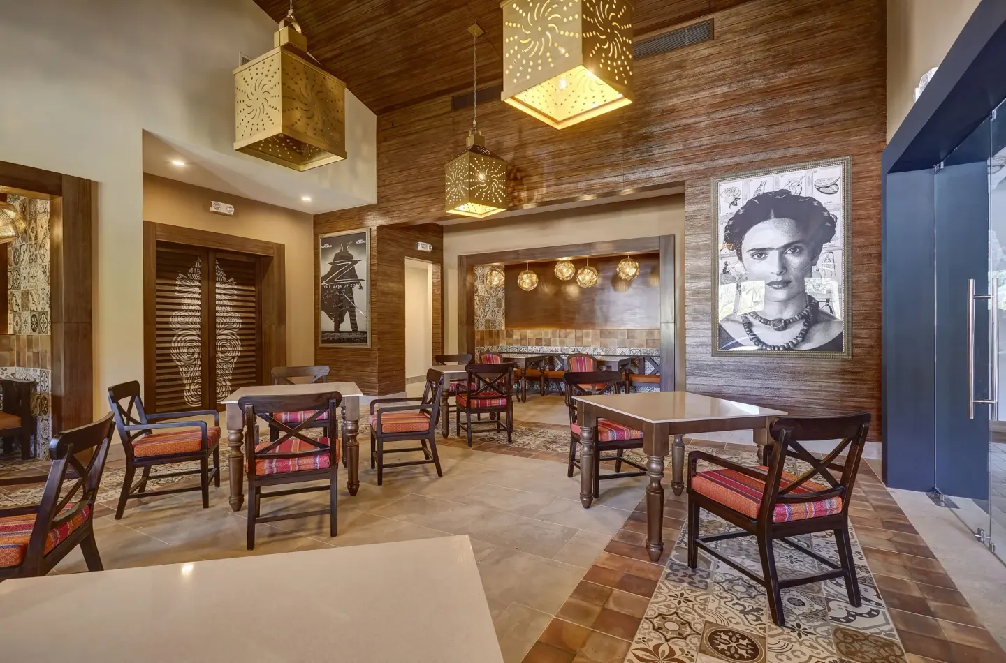 Colorful dining room with patterned tile and portrait art at Planet Hollywood Costa Rica.