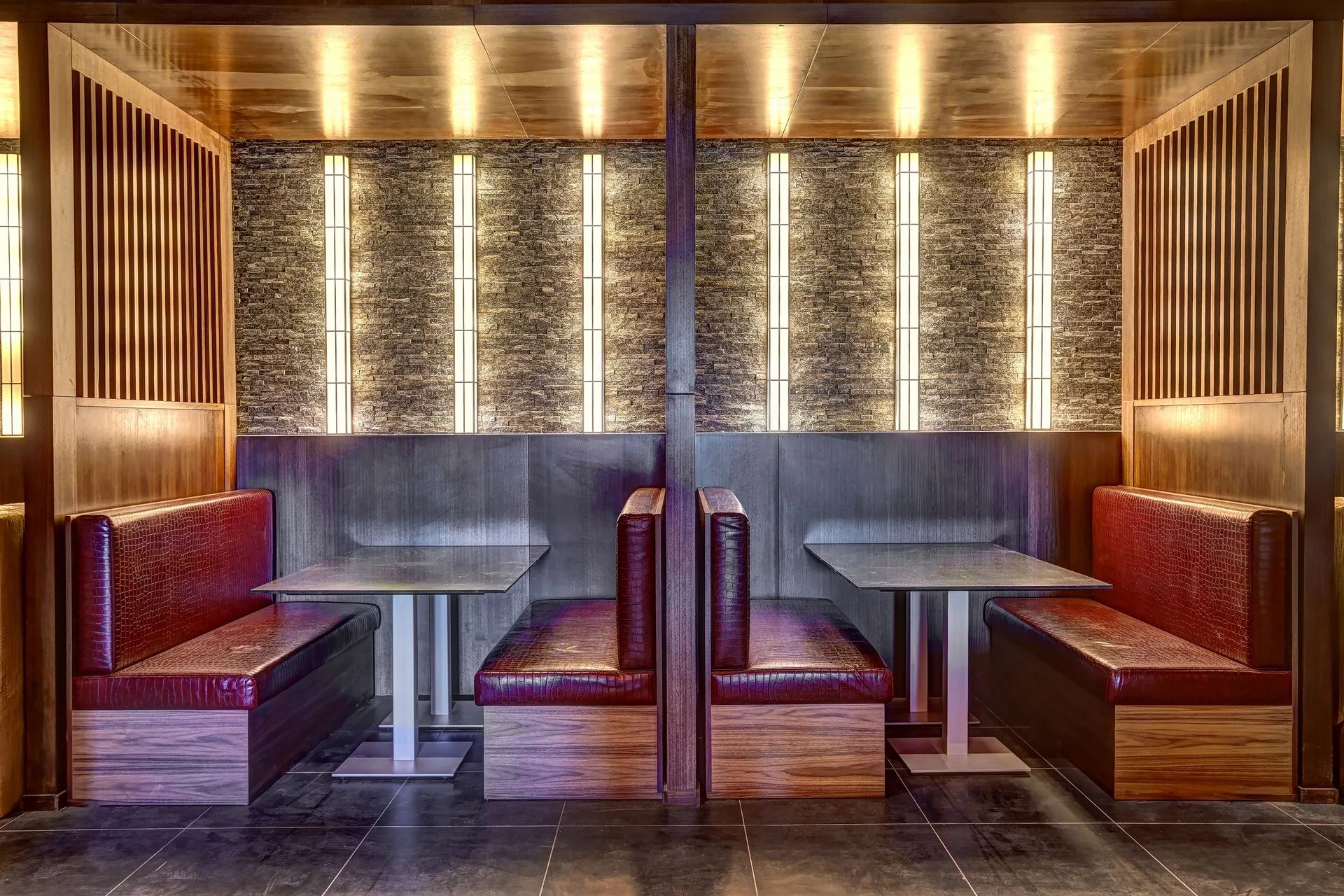 Red booth seating with vertical wall lights at Planet Hollywood Costa Rica.