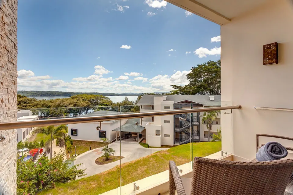 Junior Suite balcony with resort buildings and water view at Planet Hollywood Costa Rica.