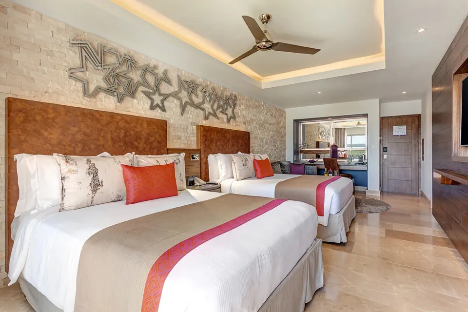 Junior Suite with two beds and star wall art at Planet Hollywood Costa Rica.