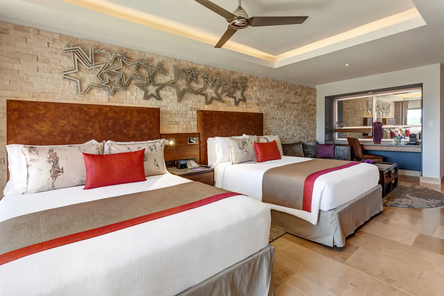 Two-bed Junior Suite with stone accent wall at Planet Hollywood Costa Rica.
