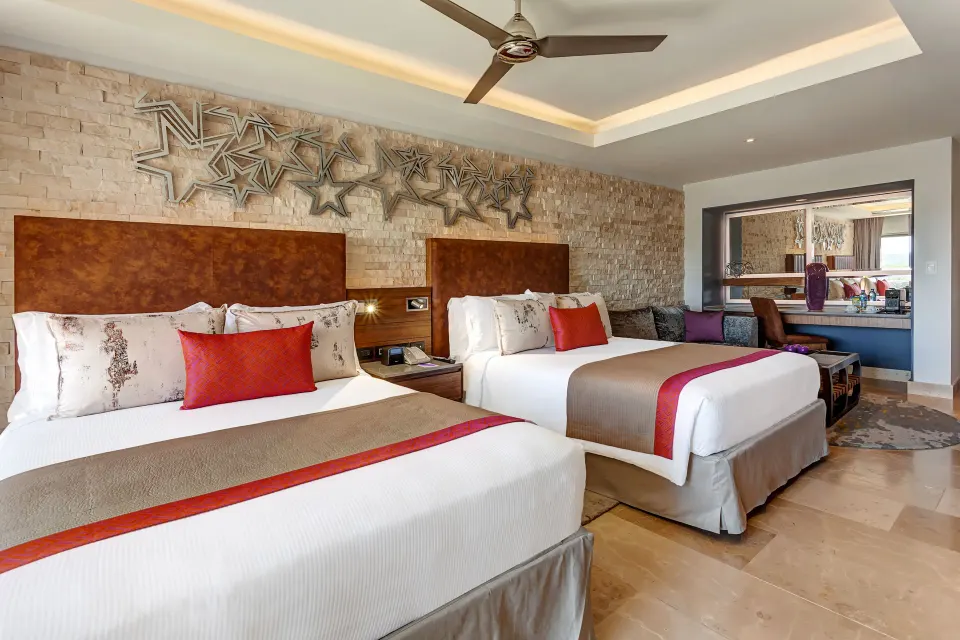 Two-bed Junior Suite with stone accent wall at Planet Hollywood Costa Rica.