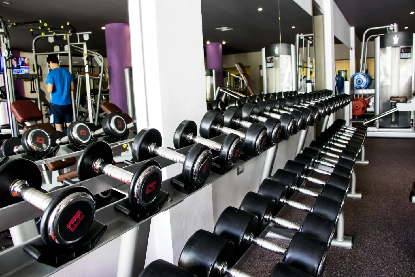 Dumbbell racks and weight machines in the gym at Platinum Yucatan Princess.