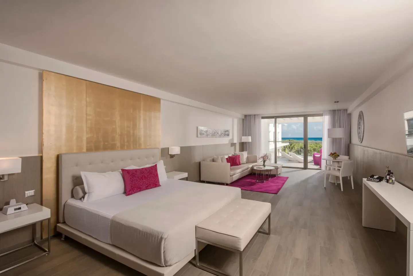 King-bed suite with sitting area and ocean view at Platinum Yucatan Princess.