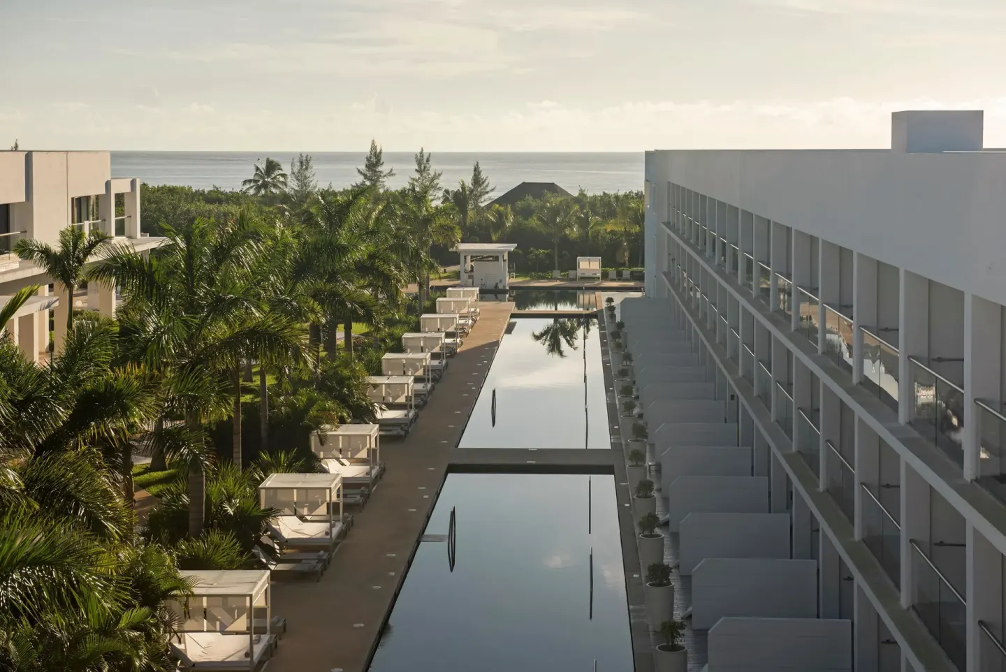 Long pool corridor between guest room buildings at Platinum Yucatan Princess.