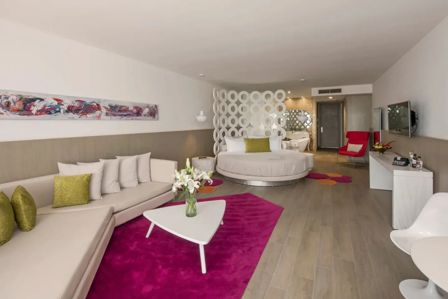 Open-plan suite with round bed and sofa at Platinum Yucatan Princess.