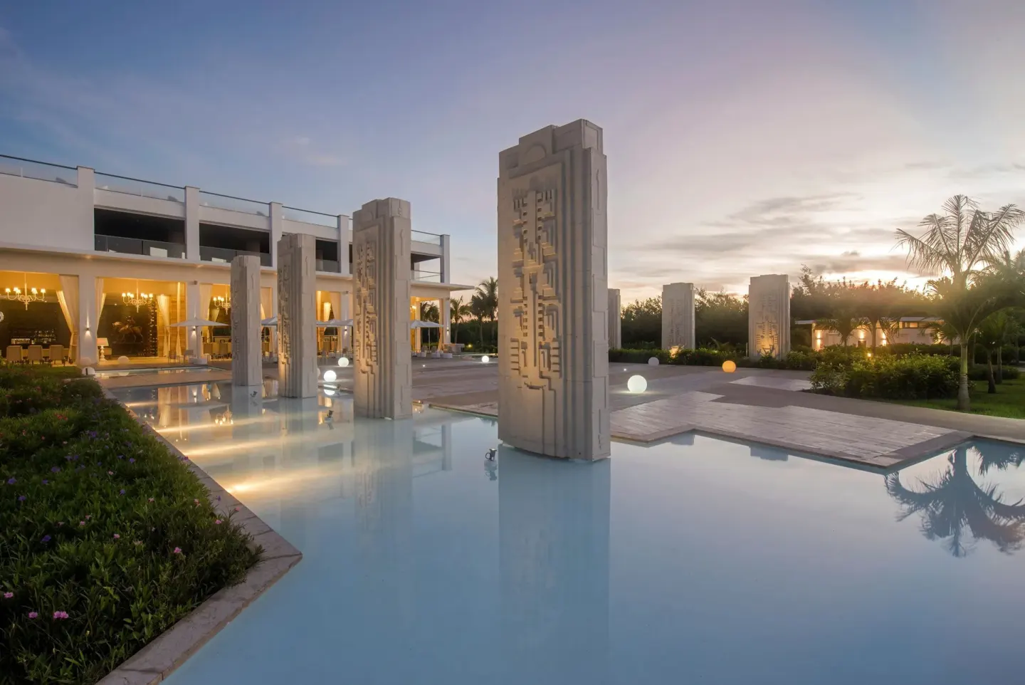 Reflecting pool with sculptural columns at sunset at Platinum Yucatan Princess.