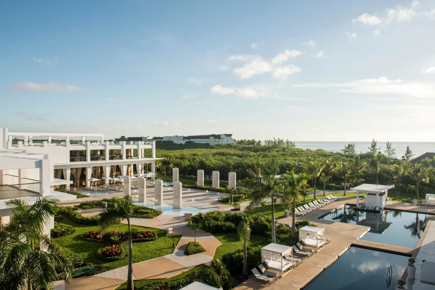 Aerial resort grounds, pools, palms and ocean beyond at Platinum Yucatan Princess.