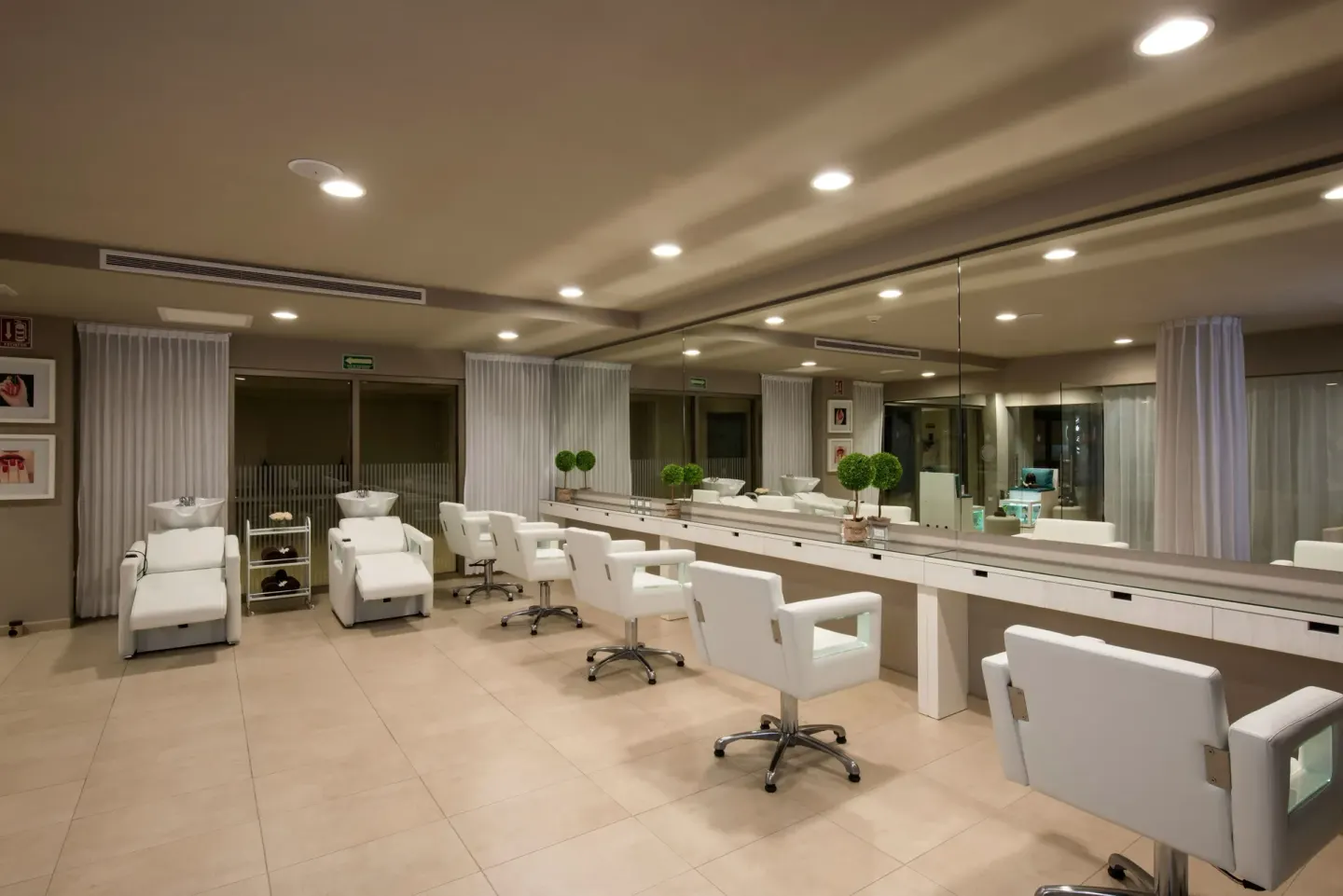 Salon room with white styling chairs and mirrored counters at Platinum Yucatan Princess.