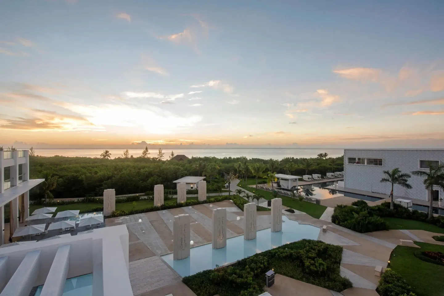 Sunset over pools and resort buildings at Platinum Yucatan Princess.