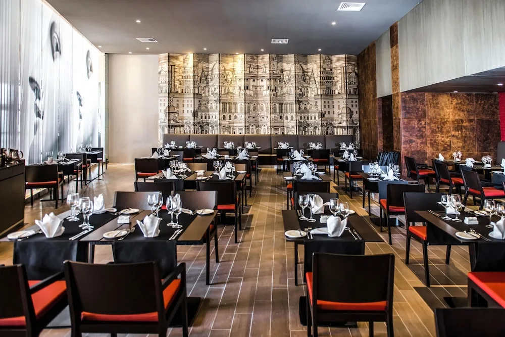 Spacious restaurant dining room with mural wall at Platinum Yucatan Princess.