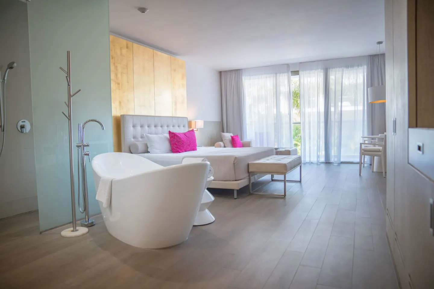 Deluxe Room with tub, bed, and balcony doors at Platinum Yucatan Princess