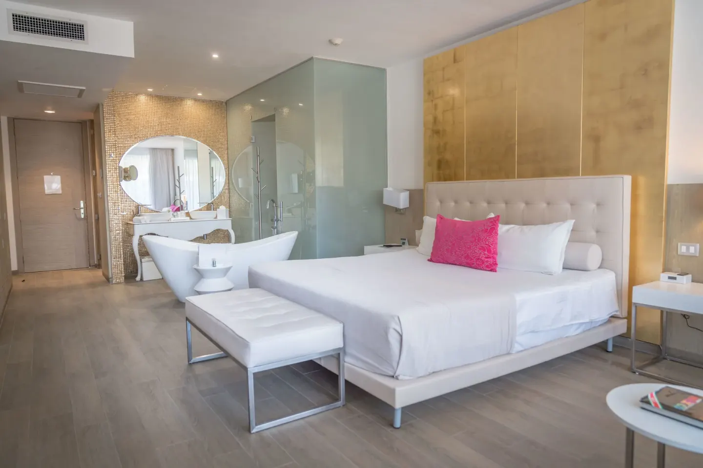 Deluxe Room with king bed, bench, tub, and vanity at Platinum Yucatan Princess